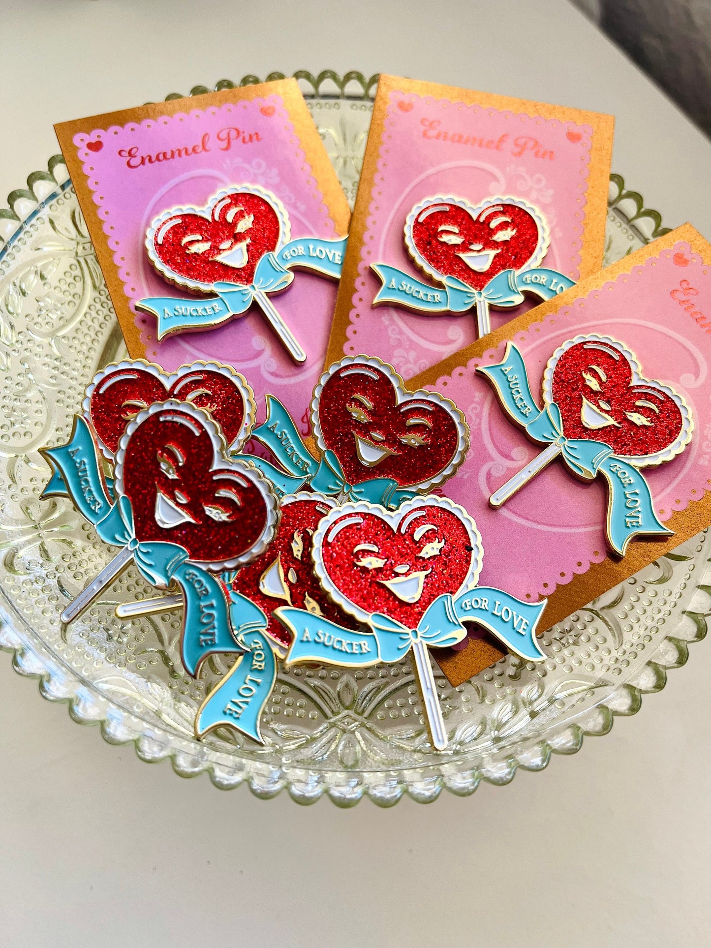 A Sucker For Love soft enamel pin with red glitter