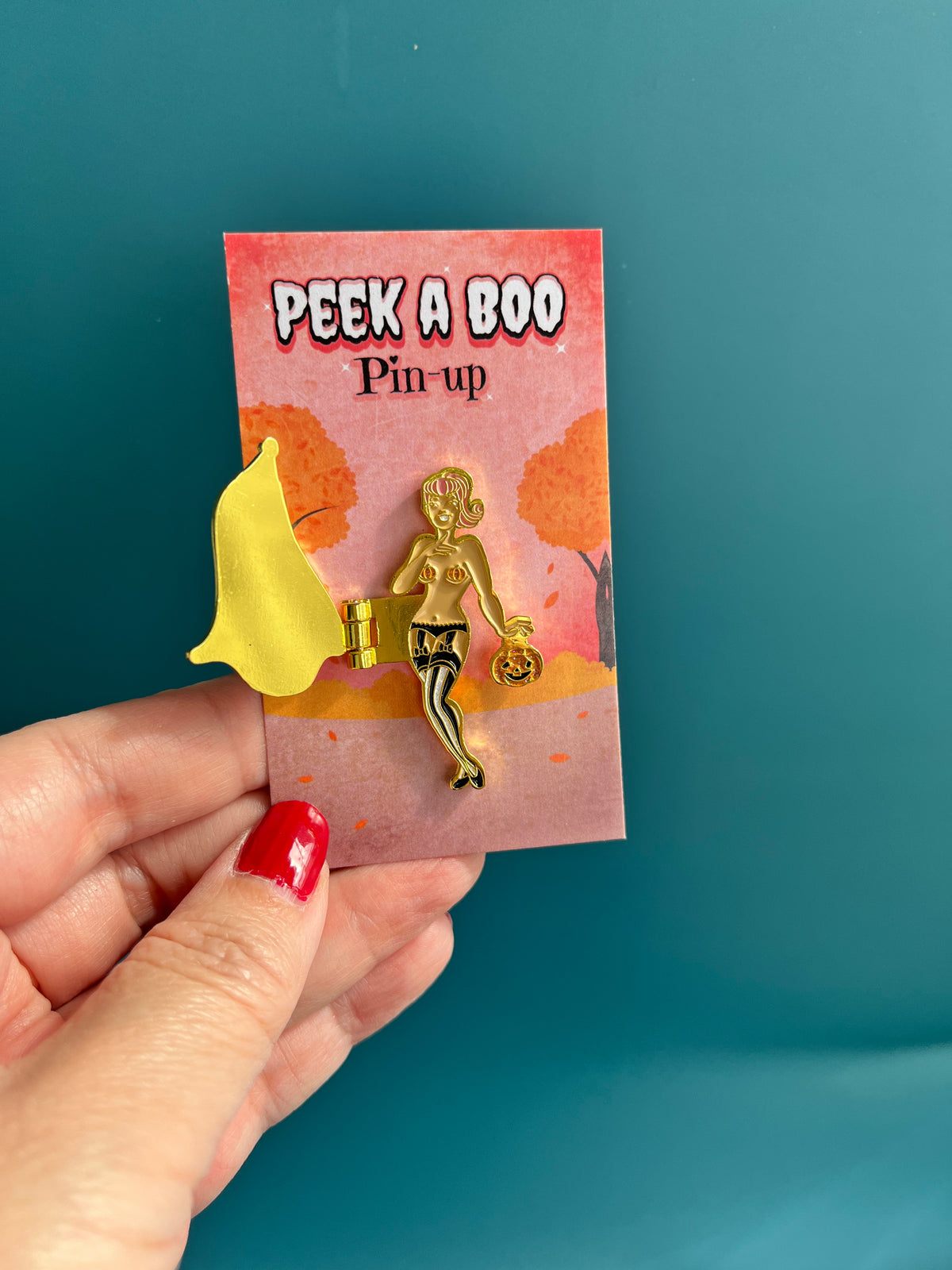 The Peek a Boo Pin-up hinge enamel pin